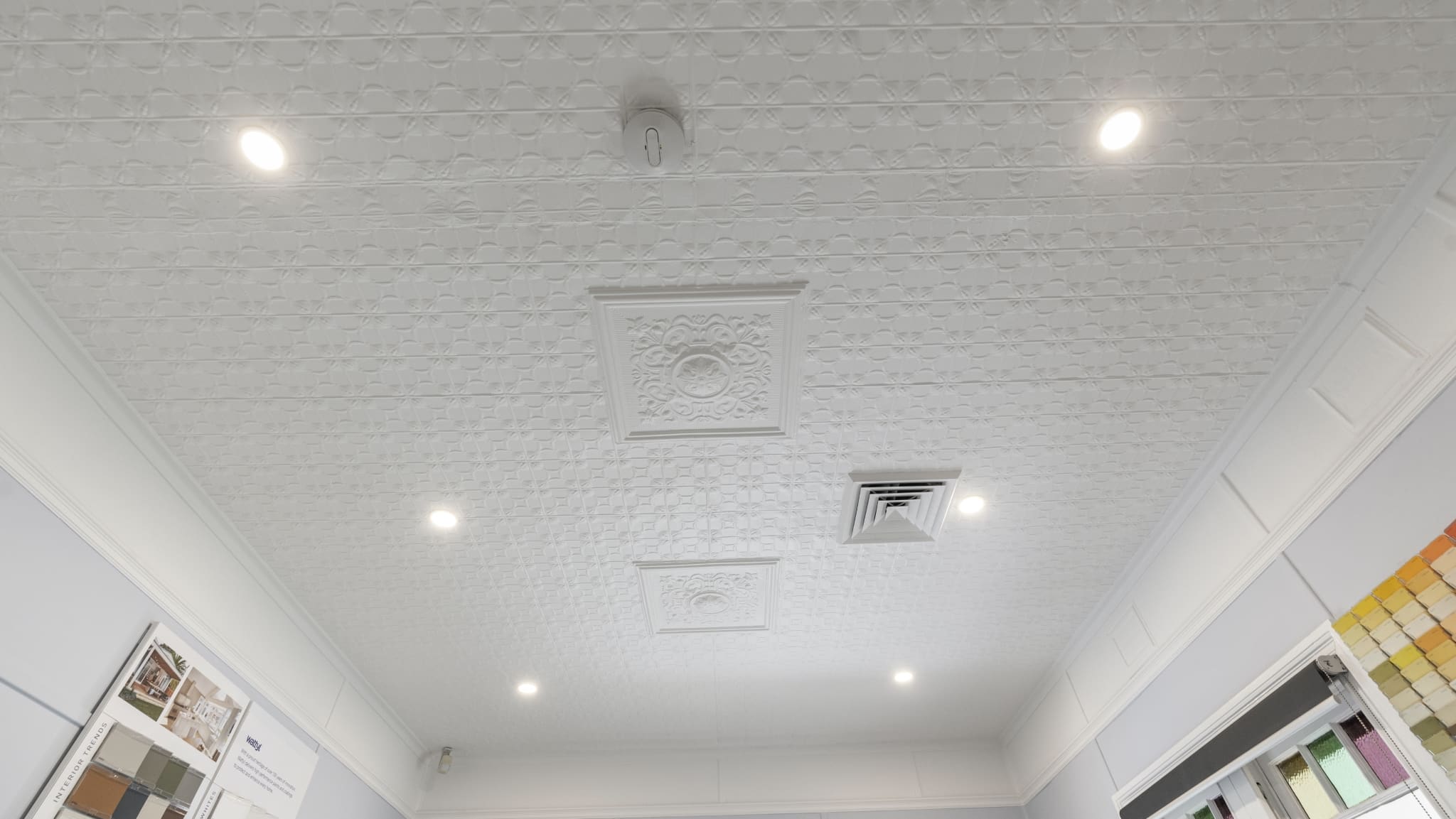 a white ceiling with patterned tiles, recessed lights, and a vent to a charming bullaburra house